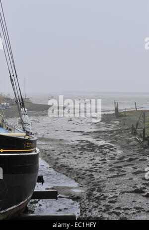 Dickens - barca ormeggiata sulla piana di fango di fiume Medway in autunno la nebbia a bassa marea. Una possibile impostazione per la scena di apertura di Foto Stock