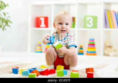 Kid ragazzo giocando dei giocattoli di legno Foto Stock