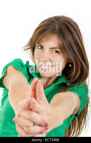 Sorridenti giovane donna che fa con le dita delle mani come segno di ripresa. Ragazza compiendo il gesto della pistola come arma isolato su bianco. Foto Stock