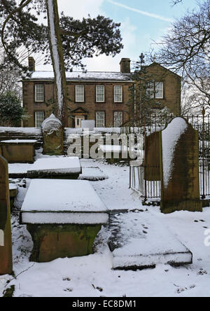 Sagrato in inverno e il Bronte Parsonage Museum, Haworth, West Yorkshire, Inghilterra. Foto Stock