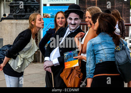 Un animatore di strada pone per le foto con i turisti al South Bank di Londra, Inghilterra Foto Stock