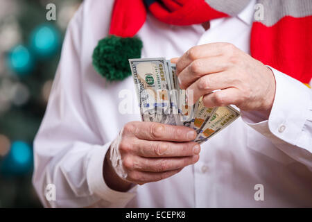 Senior uomo con denaro su sfondo di Natale Foto Stock