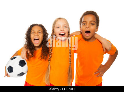 Felice di ridere e urlare soccer team di ragazzo e ragazze tenendo palla calcio avvolgente Foto Stock