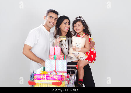 Indian genitori con bambino regalo shopping online Foto Stock