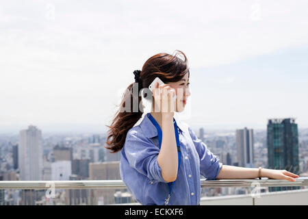 Una donna su un balcone. Foto Stock