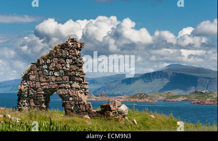 Una vista dall'isola di Iona verso Mull in Scozia il Western Isles con una parete in rovina in primo piano. Foto Stock