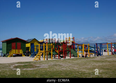 Colorata in stile vittoriano capanne sulla spiaggia e area giochi di fronte alla spiaggia in Muizenberg, vicino a Città del Capo, Sud Africa. Foto Stock