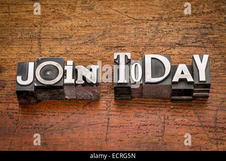 Unisciti oggi parole in un misto di metallo vintage tipo blocchi di stampa su legno di grunge Foto Stock