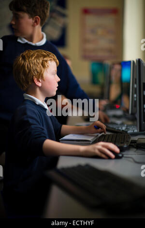 La formazione nella scuola secondaria Wales UK: un giovane ragazzo adolescente utilizzando un computer in una classe Foto Stock