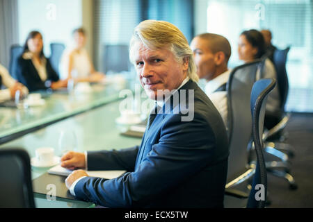 Ritratto di imprenditore seduti ad un tavolo per conferenza nella sala conferenze Foto Stock