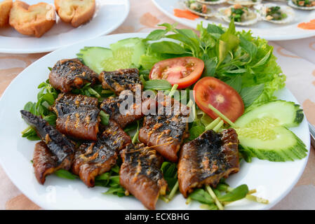 Close up di anguilla fritta con verdure e verdi Foto Stock