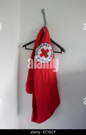 Tabard su un hangar a Croce Rossa tedesca (Deutches Rotes Kreuz - DRK) sede amministrativa a 58 Carstennstrasse, Berlino. Foto Stock