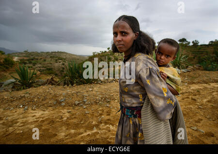 Tigrayan ragazza con bambino e tipica chiesa ortodossa etiope tatuaggi sul fronte, Etiopia Foto Stock