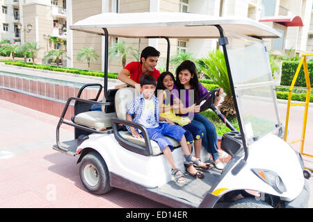 Indian i genitori con bambini parco equitazione carrello Foto Stock