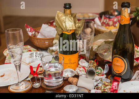 I detriti in postumi di una stagione festiva parte con un vuoto di Veuve Clicquot bottiglia di champagne e di altri rifiuti Foto Stock