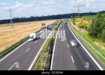 In autostrada in un paesaggio in estate e un paio di vetture Foto Stock