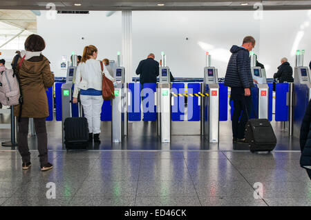 Passeggeri e viaggiatori che attraversano la zona Partenze presso l'aeroporto di Londra Stansted Essex Inghilterra Regno Unito Regno Unito Foto Stock