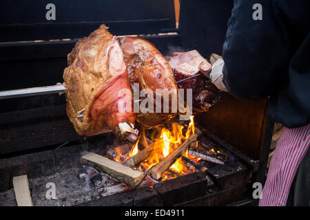 Prosciutto fritto sul fuoco aperto durante il mercatino di Natale a Staromestske namesti Piazza Città Vecchia Praga Repubblica Ceca Europa Foto Stock