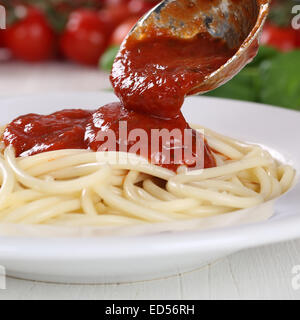 Cucinare gli spaghetti tagliatelle di pasta che serve cibo di sugo di pomodoro Napoli su piastra Foto Stock