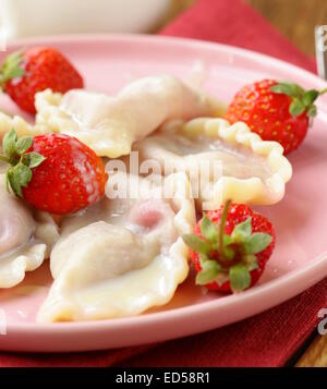 Gnocchi di patate con frutti di bosco e salsa panna con fragole fresche Foto Stock