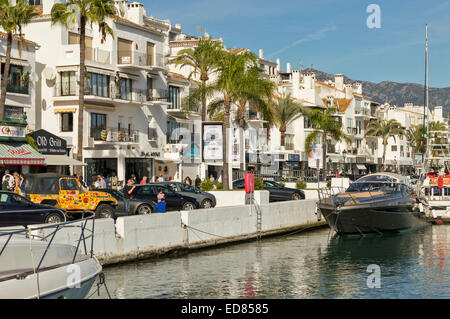 PUERTO BANUS COSTA DEL SOL SPAGNA STRADA PRINCIPALE costeggiata da negozi e barche nel porto Foto Stock