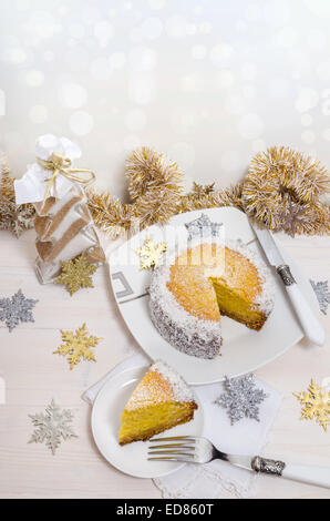 Festosa torta di zucca con noce di cocco sul tavolo e decorazione di Natale. Sfondo bokeh di fondo. A partire dalla serie di inverno la pasticceria Foto Stock