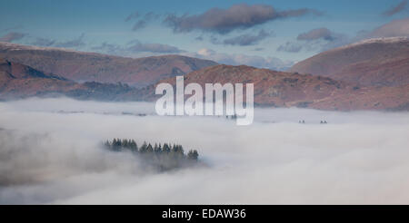 Nebbia bassa su Outgate e Skelwith, con timone roccioso nella distanza, Lake District, Cumbria Foto Stock