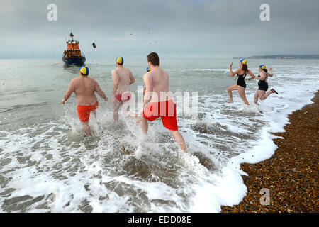 Anno nuovo tuffo in mare da Seaford bagnini, Seaford Bay, Sussex, Regno Unito Foto Stock