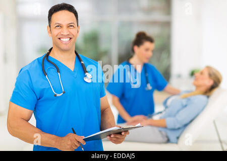 Felice metà età medico professionista in office Foto Stock