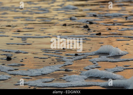 Swanage spiaggia al tramonto con il surf e la riflessione della luce Foto Stock