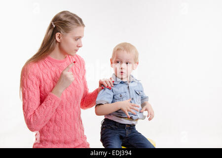 Giovane bella madre rimprovera ribelle e moody tre anno vecchio ragazzo Foto Stock