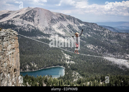 Highliner maschio nel cappello da cowboy passeggiate a piedi 125 highline su un lago in un gap sulla parte superiore della cresta Mammut Foto Stock