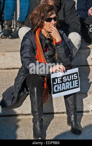 Ginevra, Svizzera. 8 gennaio 2015. Un triste o pensieroso donna tenendo un cartello di supporto durante la veglia a Ginevra's Place de Neuve per mostrare solidarietà con le vittime dell attentato contro Charlie Hebdo. Credito: Alistair Scott/Alamy Live News Foto Stock