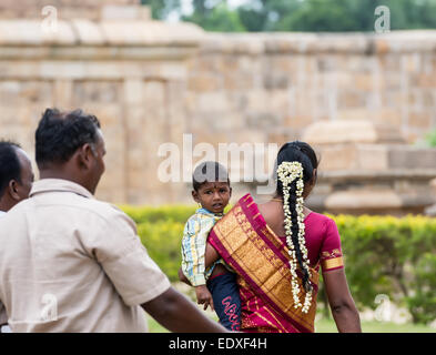 THANJAVOUR, India - 13 febbraio: Un indiano non identificato persona in abito nazionale di trasportare un bambino nelle mani. India, Tamil Na Foto Stock