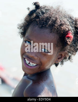 Ragazza giovane dal vicino villaggio di poveri pone per foto in mare dei Caraibi vicino a Cartagena, Colombia. Foto Stock