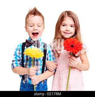 Ritratto di carino coppia di bambini con fiori in mani Foto Stock