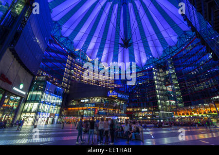 Giovani rilassarsi e socializzare in una accesa il Sony Center di notte, Potsdamer Platz, Berlin, Germania, Europa Foto Stock