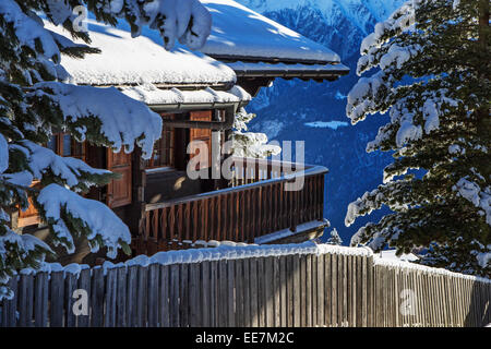 Coperta di neve Swiss chalet in legno in inverno nelle Alpi, Wallis / Valais, Svizzera Foto Stock