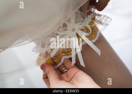 Giarrettiera sulla gamba di una sposa Foto Stock