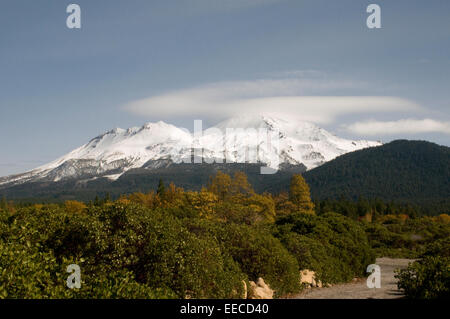 Cielo blu, rivestita di neve & luce nube coprì il monte Shasta con Aspen e le foreste in primo piano Siskiyou County California USA Foto Stock