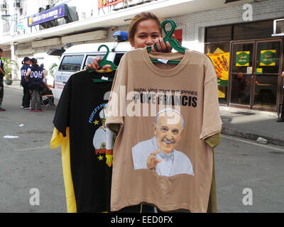 Manila, Filippine. 16 gennaio, 2015. I fornitori di Intramuros, Manila la vendita di diversi cimeli papale come perni di pulsante, calendari, ventole e t-shirt con Papa Francesco immagini. Credito: Sherbien Dacalanio / Alamy Live News Foto Stock