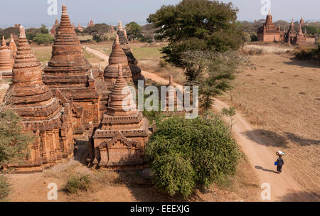 Donna camminare vicino a pagode, Bagan, Myanmar Foto Stock