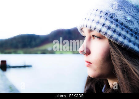 Giovane ragazza in cappellino guardando fuori in distanza Foto Stock