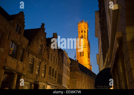 Belfort-Hallen torre campanaria da Wollestraat accesa fino al crepuscolo, Bruges, Belgio Foto Stock