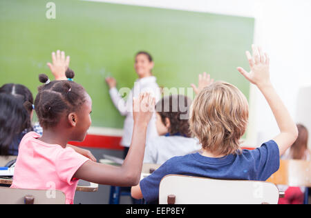 Ritratto di bambini ha suscitato le loro mani in un multi etnico in aula. Foto Stock