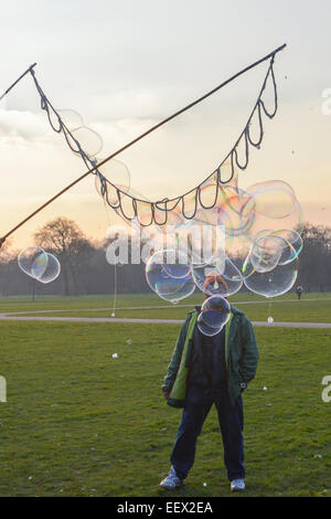 Hyde Park, London, Regno Unito. Il 22 gennaio 2015. Richard Shaw crea bolle di sapone come il sole tramonta in un freddo giorno di Hyde Park, Londra. Credito: Matteo Chattle/Alamy Live News Foto Stock