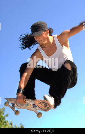 Guidatore di skateboard facendo un'antenna Foto Stock