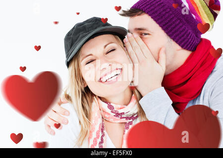 Immagine composita della coppia giovane la condivisione di un segreto Foto Stock