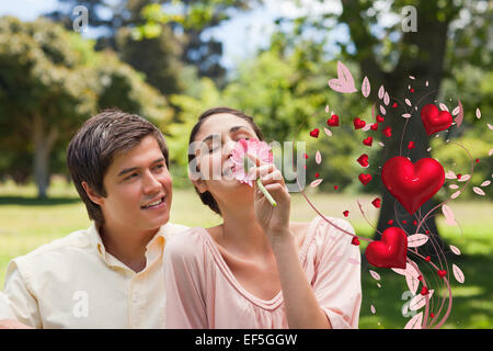 Immagine composita dell'uomo a guardare il suo amico mentre ella è odore di un fiore Foto Stock
