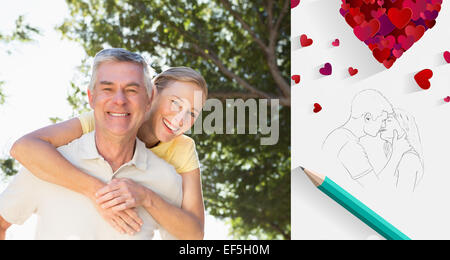 Immagine composita di felice senior uomo dando il suo partner un piggy back Foto Stock